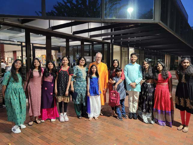 Student receiving recognition for mixed media artwork